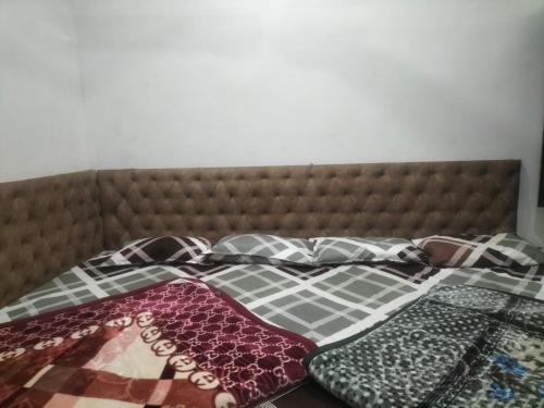 a bed with two pillows on top of it at Shree Gopal Niketan in Mathura