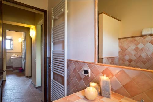a bathroom with a counter with two candles on it at Agriturismo Podere Campaini in Volterra