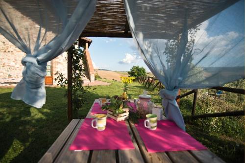 a picnic table with a pink table cloth on it at Agriturismo Podere Campaini in Volterra