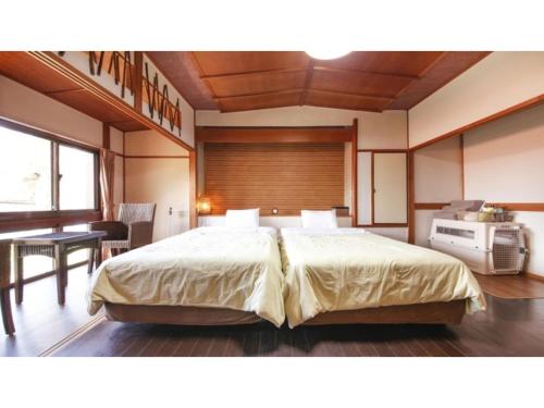 a bedroom with a large bed in a room at Japari Tateyama - Vacation STAY 76023v in Tateyama