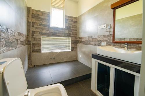 a bathroom with a sink and a mirror at Thimaya Holiday Resort in Hatton