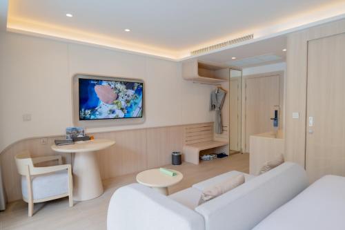 a living room with a couch and a table at Wyndham Garden Naithon Phuket in Nai Thon Beach