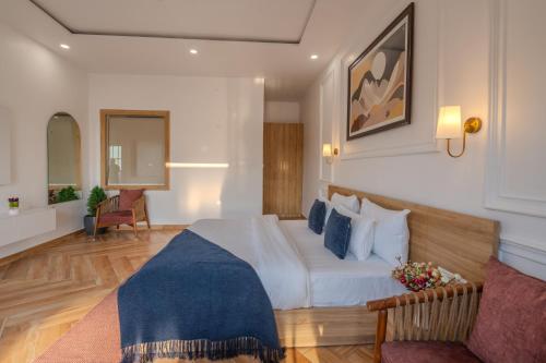 a hotel room with a bed and a couch at SaffronStays The Rajpur in Rājpur
