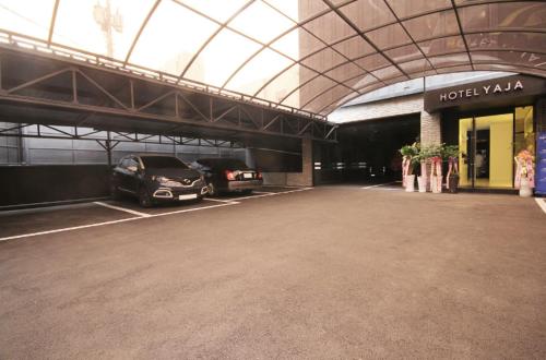 a hotel parking lot with a car parked in it at Hotel YAJA Gwangju Hanam branch in Gwangju