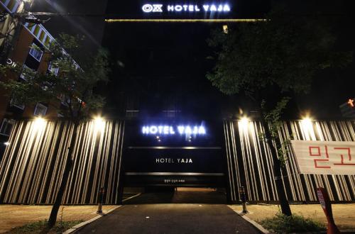 a bus is parked in a street at night at Hotel YAJA Gwangju Hanam branch in Gwangju