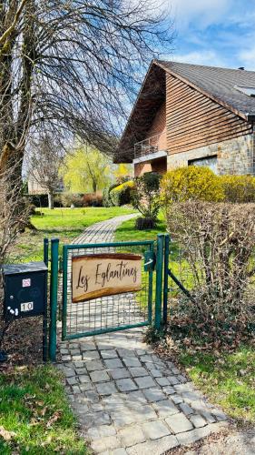 a sign on a gate in front of a house at Les Églantines in Marche-en-Famenne