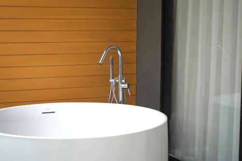 a bathroom with a white sink and a faucet at Wyndham Garden Naithon Phuket in Nai Thon Beach