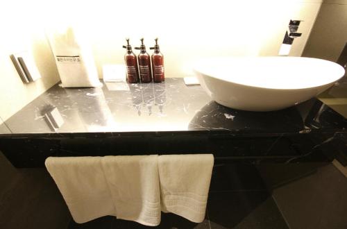 a bathroom with a sink and a counter with towels at Hotel YAJA Gwangju Hanam branch in Gwangju