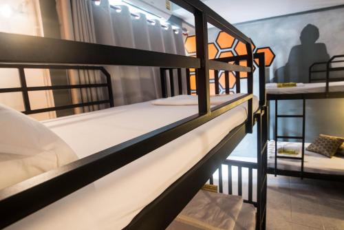 a couple of bunk beds in a room at Beehive Phuket Old Town Hostel in Phuket Town