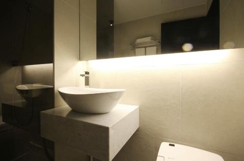a bathroom with a white sink and a toilet at Hotel YAJA Gwangju Hanam branch in Gwangju