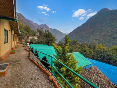 a building with a view of a river and mountains at Cradle of Life in Shivpuri