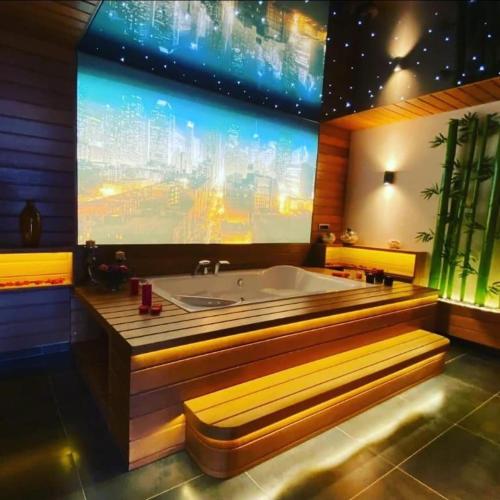 a large bathroom with a tub and a large screen at Utopia Suite in Burunabat