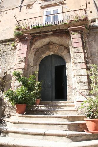 an entrance to a building with a black door at Al vecchio castello in Tropea