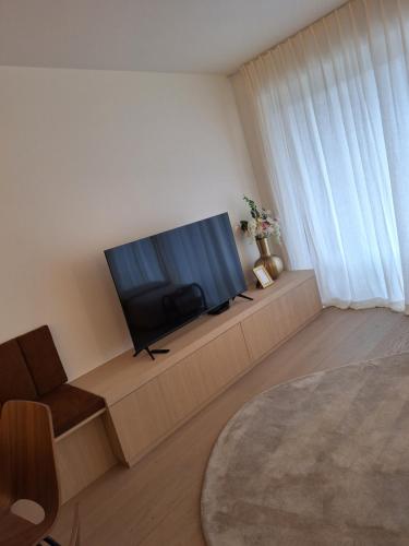 a living room with a flat screen tv sitting on a couch at Appartement Wellington D3 Knokke full service et parking in Knokke-Heist