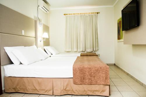 Ένα ή περισσότερα κρεβάτια σε δωμάτιο στο Hotel O Casarão