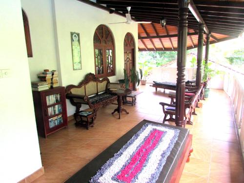 a living room with a rug on the floor at Sankarest Villa in Kosgoda