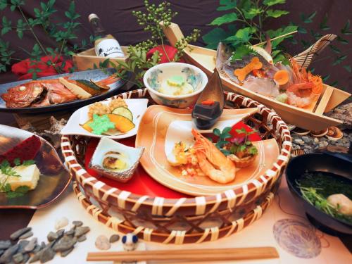 a table topped with plates of food on a table at Japari Tateyama - Vacation STAY 84008v in Tateyama
