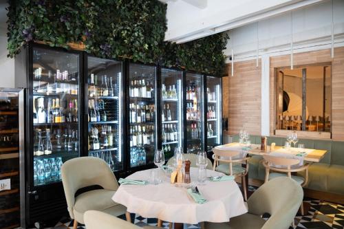 a restaurant with tables and chairs and shelves of wine bottles at Barrique Garden in Braşov