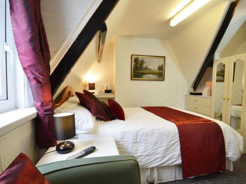 a bedroom with a bed and a desk with a chair at South Shore Guest House in South Shields