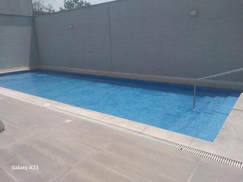 a swimming pool with blue water in a building at Moderno departamento con vista panorámica cerca a los centros comerciales in Lima