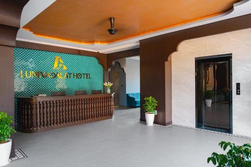 an entrance to a hotel with a sign on the wall at Lumina Dalat Premium in Xuan An
