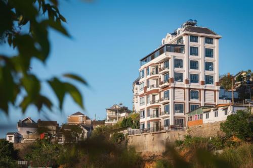 a tall white building sitting on top of a hill at Lumina Dalat Premium in Xuan An