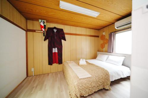 Ένα ή περισσότερα κρεβάτια σε δωμάτιο στο Ikebukuro Base