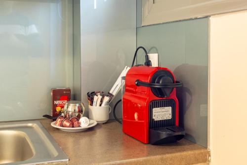 a red toaster sitting on top of a kitchen counter at Avia Blue Maisonettes - Messinia Gulf Retreat in Avia
