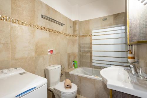 a bathroom with a toilet and a sink and a tub at Avia Blue Maisonettes - Messinia Gulf Retreat in Avia