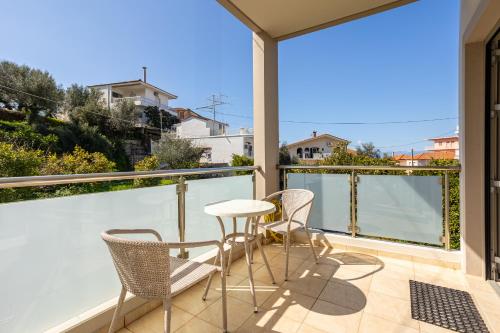 a patio with chairs and a table on a balcony at Avia Blue Maisonettes - Messinia Gulf Retreat in Avia