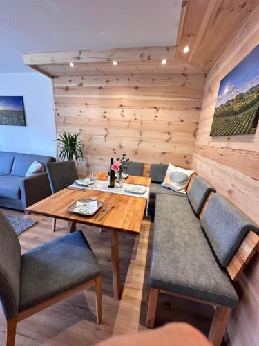 a wooden dining room with a wooden table and chairs at Ferienhaus Muskatellerhof in Silz