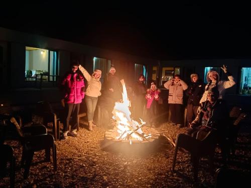 a group of people standing around a fire at Mystic Pangong in Spangmik