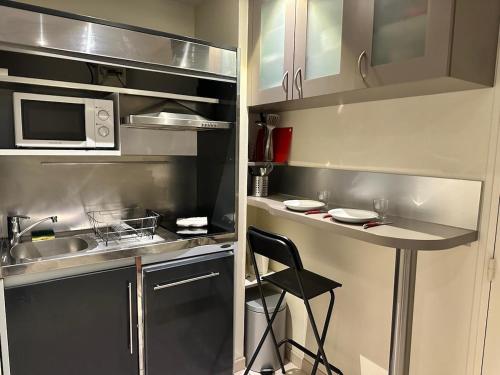 La cuisine est équipée d'un comptoir, d'un évier et d'un four micro-ondes. dans l'établissement CHARMANT Studio 100 M Gare, à Tours