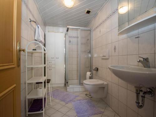 a bathroom with a sink and a toilet and a shower at Gästehaus Resi in Bad Peterstal-Griesbach