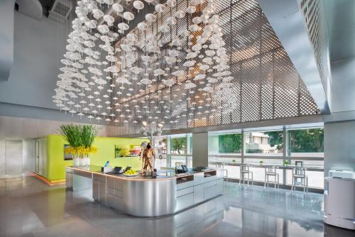 a lobby with a large chandelier in a building at Pagoda Hotel Shenzhen Familytrip&BusinessTravel in Shenzhen