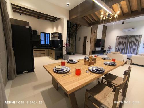 a dining room and living room with a wooden table at Lions Den luxury 4 BHK with private pool at tiger point near cloud nine in Āmbavna