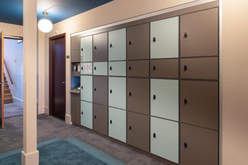 a room with lockers and a hallway at Stayokay Hostel Amsterdam Stadsdoelen in Amsterdam