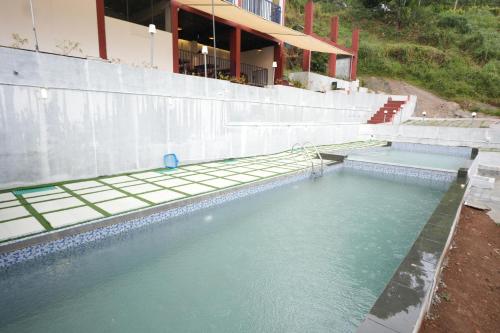 a pool of water in front of a building at Velvet Vista Munnar in Munnar