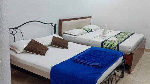 two beds sitting next to each other in a room at Blue ocean apartment baga Kyle in Calangute
