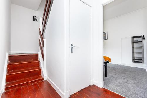 an open hallway with white walls and wood floors at 5 Individual Beds - Free Parking in Coatbridge