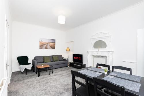 a living room with a couch and a table at 5 Individual Beds - Free Parking in Coatbridge