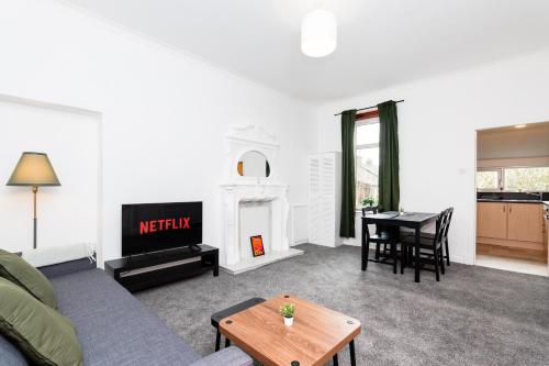 a living room with a couch and a table at 5 Individual Beds - Free Parking in Coatbridge