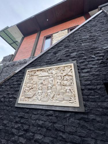 a stone carving on the side of a building at Murni’s House in Lovina