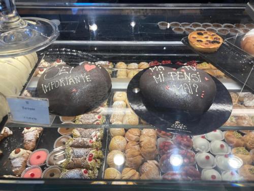a display case filled with lots of different types of pastries at MaryGrace B&B in Castellammare di Stabia