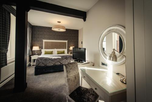 a hotel room with a large bed and a large mirror at Hotel Isaacs Cork City in Cork