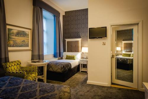 a hotel room with a bed and a television at Hotel Isaacs Cork City in Cork