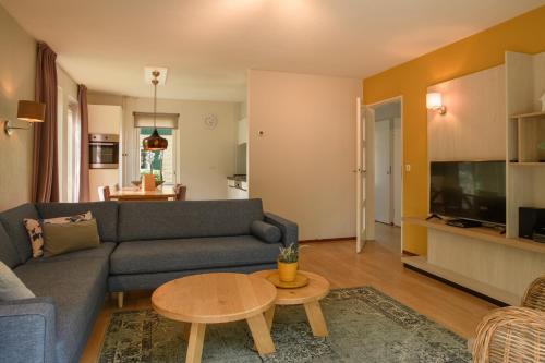 a living room with a couch and a table at Summio Parc Duc de Brabant in Westelbeers
