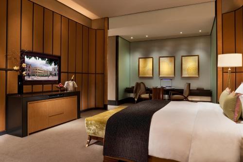 a hotel room with a bed and a television at MGM Macau in Macau