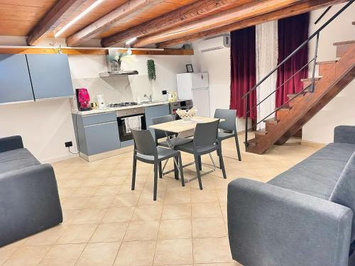 a kitchen and dining room with a table and chairs at Siloe Apartment Palermo in Palermo