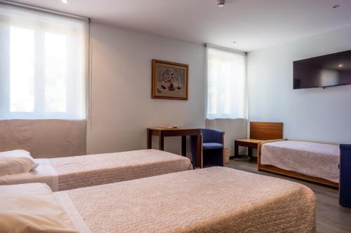 Postel nebo postele na pokoji v ubytování Hotel San Giorgio
